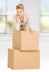 Image showing attractive businesswoman with big boxes