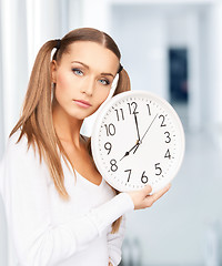 Image showing woman holding big clock