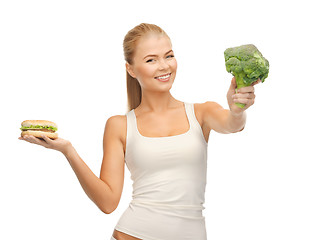 Image showing woman with broccoli and hamburger