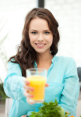 Image showing woman holding glass of orange juice