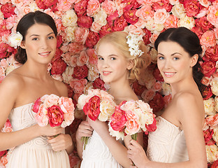 Image showing three women with background full of roses