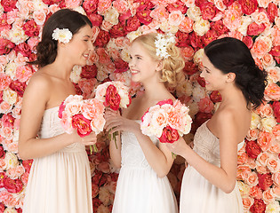 Image showing three women with background full of roses