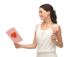 Image showing young woman holding flower and postcard