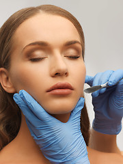 Image showing woman face and beautician hands