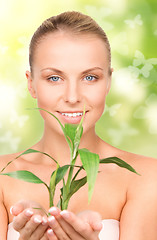 Image showing woman with sprout and butterflies