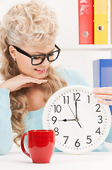 Image showing attractive businesswoman with clock and red cup