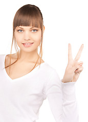 Image showing young woman showing victory sign