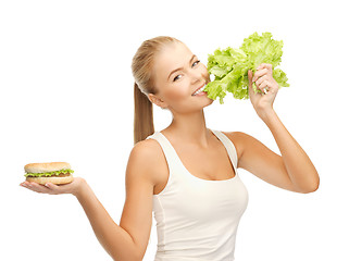 Image showing woman with green lettuce and hamburger