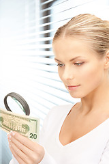 Image showing woman with magnifying glass and money