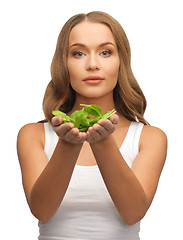 Image showing woman with spinach leaves on palms