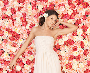 Image showing young woman with background full of roses