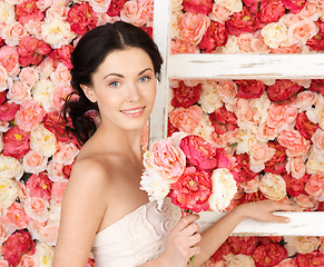 Image showing woman with old ladder and background full of roses