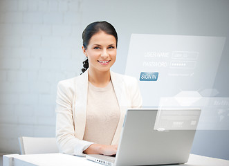 Image showing woman with laptop computer and virtual screen