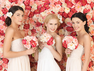 Image showing three women with background full of roses