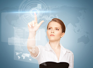 Image showing businesswoman touching virtual screen