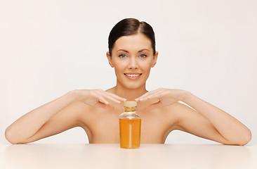 Image showing woman with oil bottle