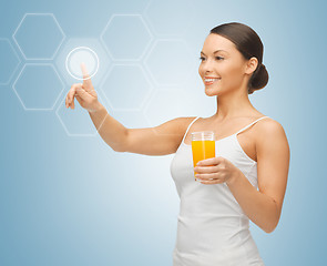 Image showing woman with glass of juice and virtual screen