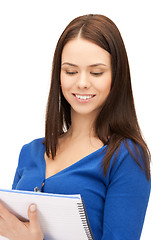 Image showing smiling young businesswoman with notebook