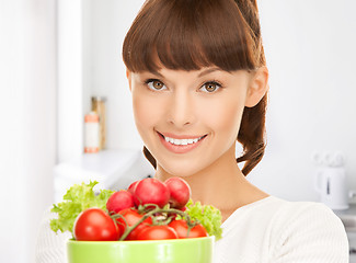 Image showing woman in the kitchen with tomatoes