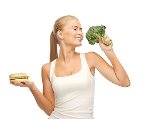 Image showing woman with broccoli and hamburger