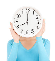 Image showing businesswoman with clock over her face