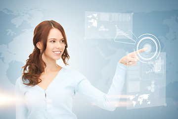 Image showing businesswoman touching virtual screen