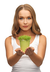 Image showing woman with green grass in pot