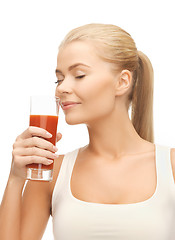 Image showing young woman drinking tomato juice