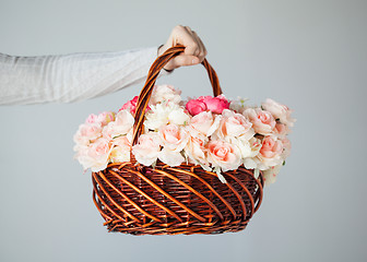 Image showing man's hand holding basket full of flowers