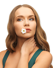 Image showing woman with camomile in mouth