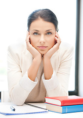 Image showing bored and tired woman behid the table