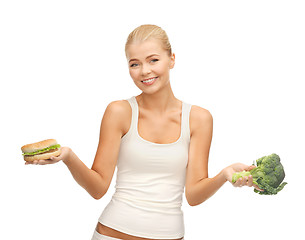 Image showing woman with broccoli and hamburger