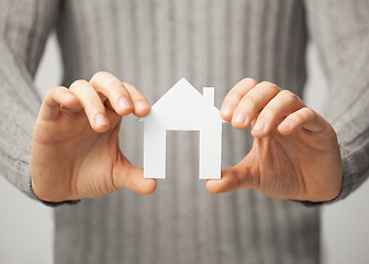 Image showing man holding paper house