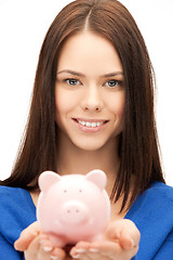 Image showing lovely woman with small piggy bank