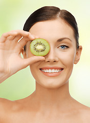 Image showing woman with kiwi slice