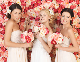 Image showing three women with background full of roses