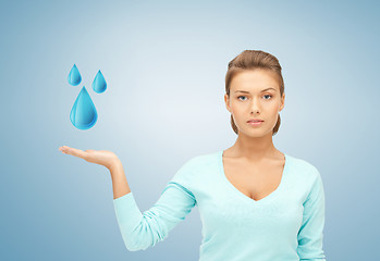Image showing woman showing blue water drops