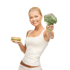 Image showing woman with broccoli and hamburger