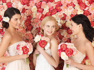 Image showing three women with background full of roses