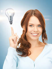 Image showing woman pointing her finger at light bulb