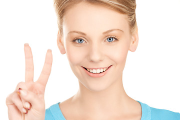 Image showing young woman showing victory or peace sign