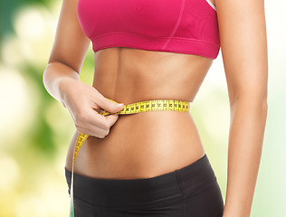 Image showing trained belly with measuring tape