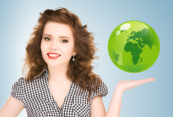 Image showing woman holding green globe on her hand