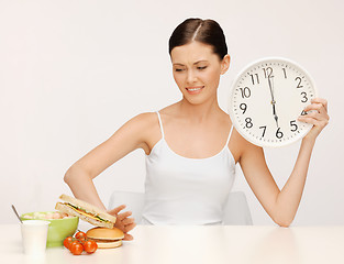 Image showing woman with big clock