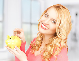 Image showing woman with piggy bank and cash money