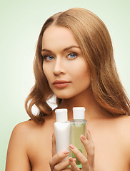 Image showing woman with cosmetic bottles