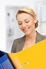 Image showing smiling woman with folders