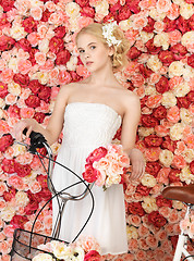 Image showing woman with bicycle and background full of roses