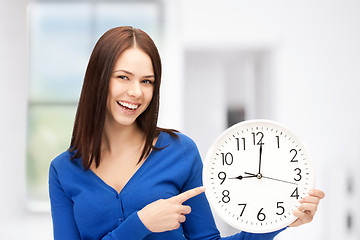 Image showing woman holding big clock