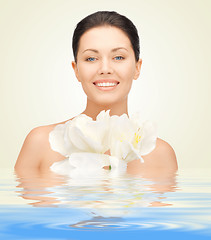 Image showing woman with orchid flower in water